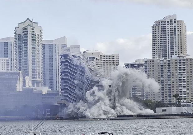 How do you safely demolish a 23-story hotel in the middle of a dense waterfront neighborhood, in just seconds?