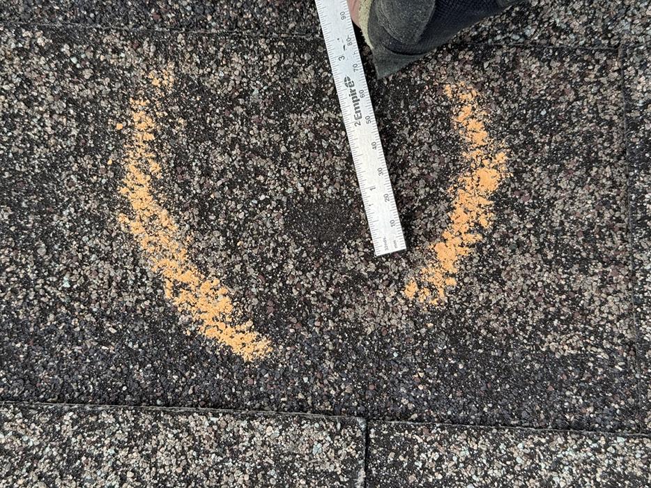 Hail impact on asphalt shingles.