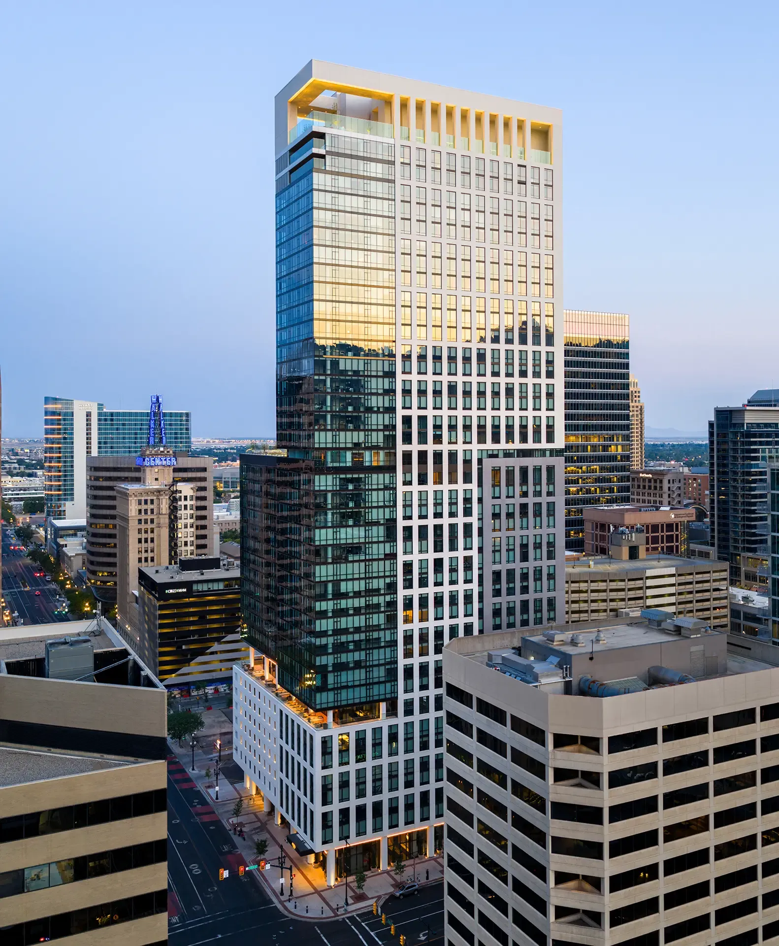 The structural system uses post-tensioned concrete slabs and columns, with concrete shear walls at the core and stairways for lateral support.