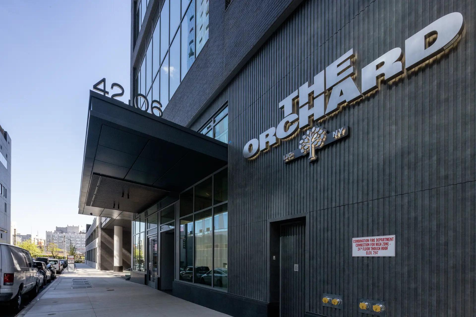 Street-level view of The Orchard’s entrance and exterior signage in Long Island City, Queens.