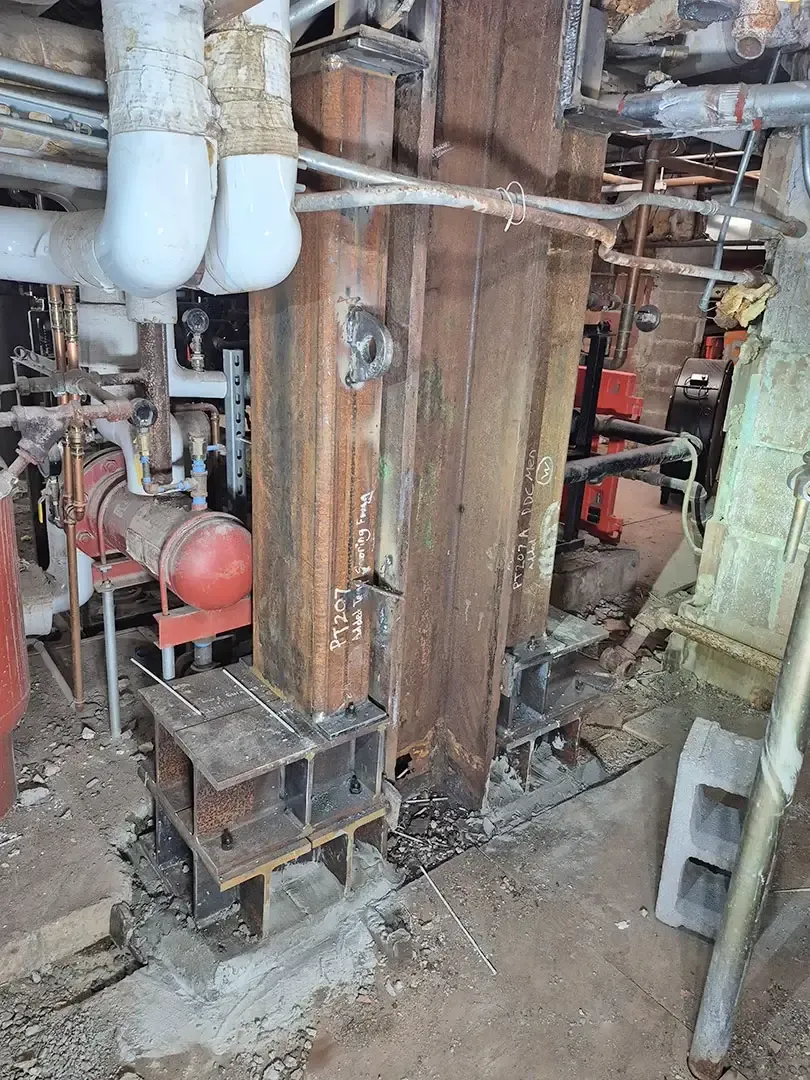 Our team mapped corrosion and structural distress throughout the steel framing and floor systems and developed a probing program that combined nondestructive testing with selective openings to quantify section loss in beams, slabs, columns, and stairs. 