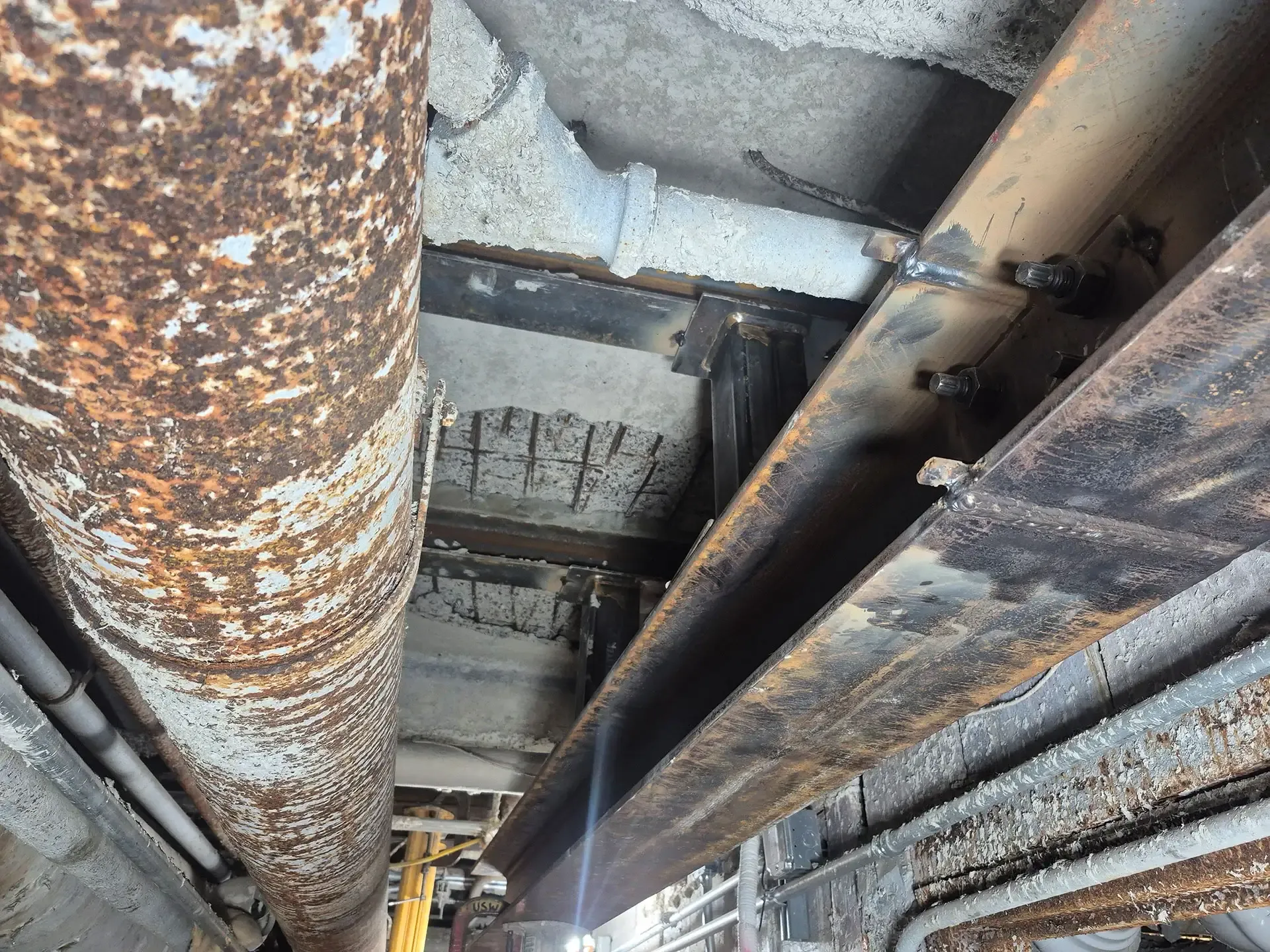 Slab stabilization strategy overcoming complicated field condition of congested overhead equipment