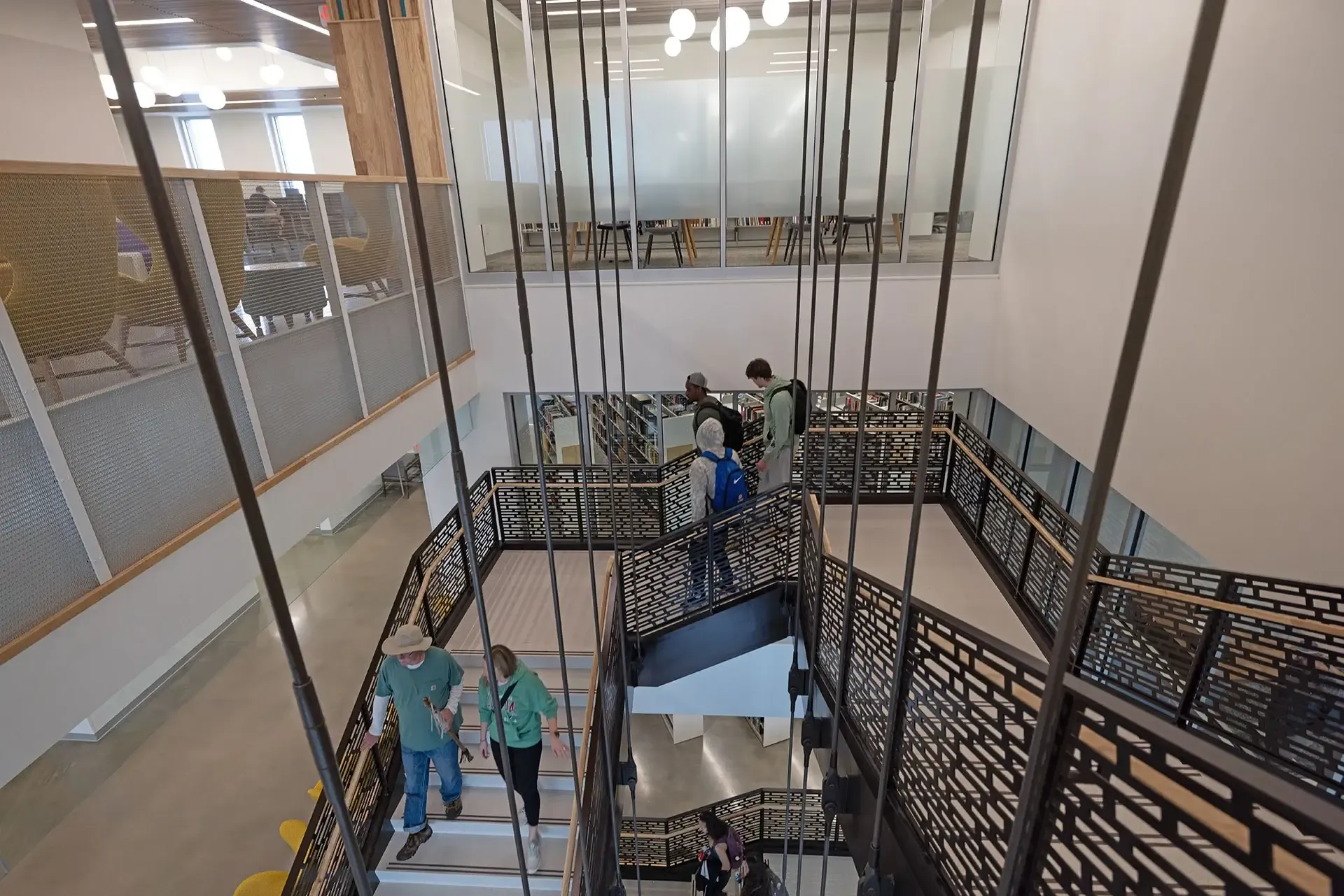The staircase was designed to structurally self-supporting between floor levels, but to improve vibration performance and reduce movement, we incorporated several slender pretensioned support rods, suspended from the ceiling. 