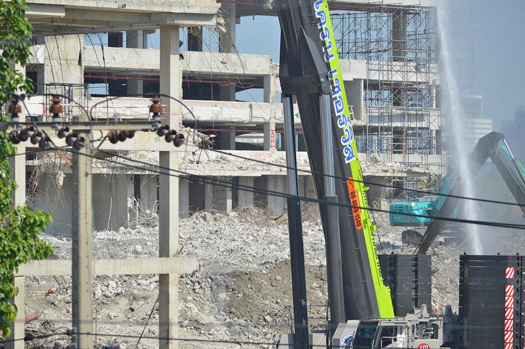 The image illustrates damage to a neighboring building in the same complex, caused during the collapse of a 30-storey tower under construction.